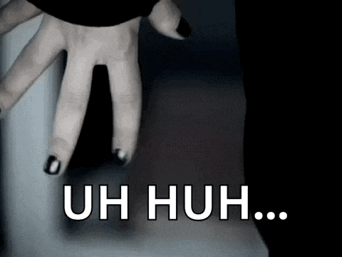 a close up of a person 's hand with black nail polish .