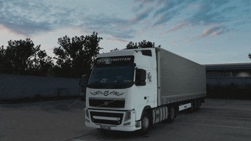 a volvo truck is parked in a dark parking lot