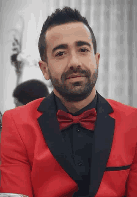 a man in a red suit and bow tie