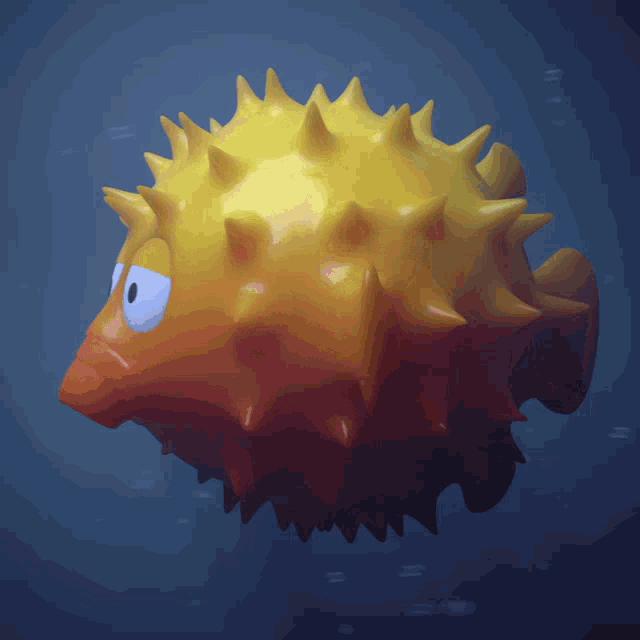 a yellow and orange puffer fish with blue eyes is swimming in the ocean