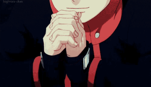 a close up of a person 's hands with a red hoodie on