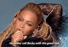 a woman singing into a microphone with the words " he better call becky with the good hair "