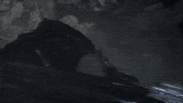 a black and white photo of a person 's face in the dark