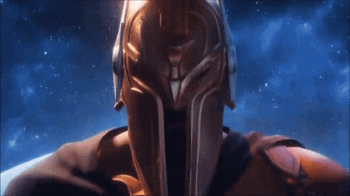 a man in a helmet with blue eyes is looking at the camera .