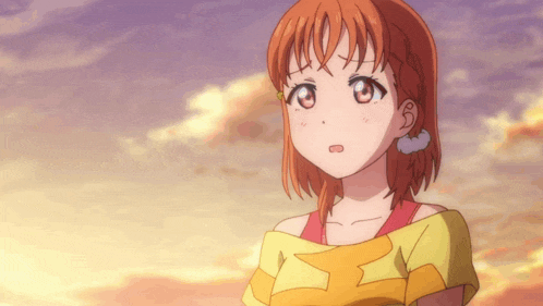 a girl with orange hair is wearing a yellow shirt with the letter x on it