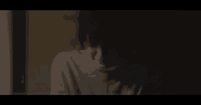 a close up of a person 's face with a bandage on it in the dark .