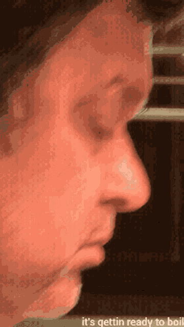 a close up of a man 's face with the words it 's gettin ready to boil below