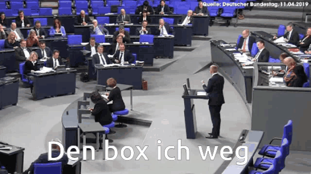 a man stands at a podium with the words den box ich weg written on the bottom