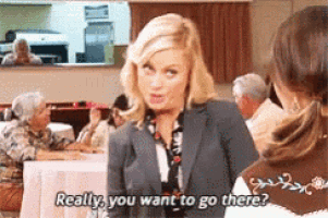 a woman in a suit is talking to another woman in a restaurant and says really you want to go there ?