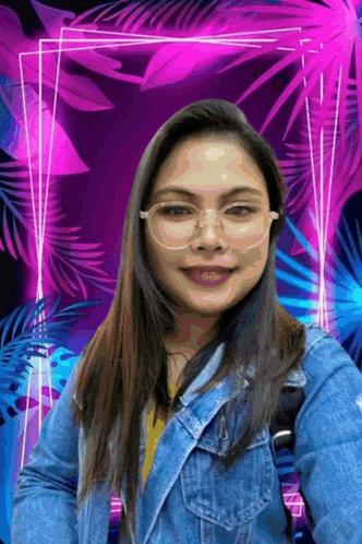 a woman wearing glasses and a denim jacket stands in front of a purple and blue background