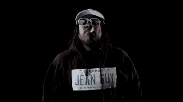 a man wearing a blue hat and glasses is wearing a jean guy hoodie