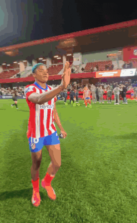 a soccer player wearing a red and white striped shirt with the number 10