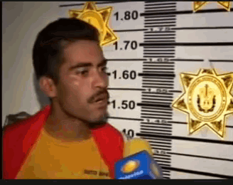 a man is standing in front of a wall with a ruler that has 1.80 on it