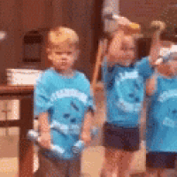 a group of young children wearing blue shirts that say ' sharks '