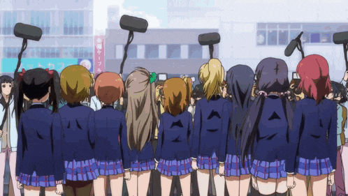 a group of girls are standing in front of a building with a sign that says cafe