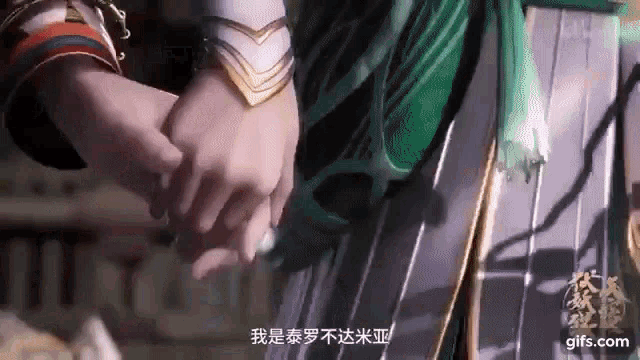 a person holding another person 's hand with chinese writing on the bottom