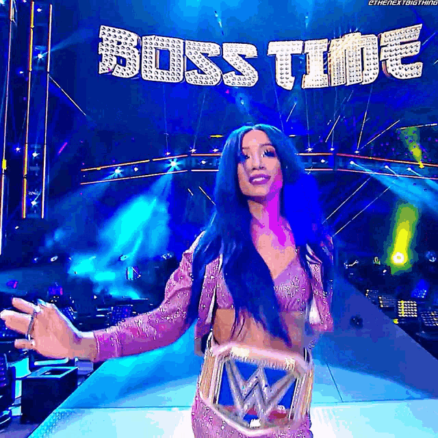 a woman in a pink dress is on a stage with the words boss time behind her