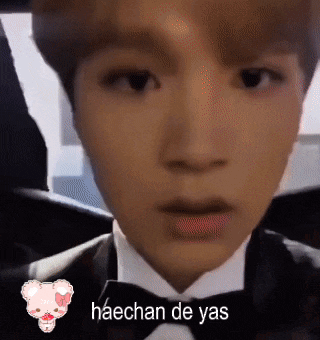 a close up of a man in a tuxedo with the words haechan de yas on the bottom