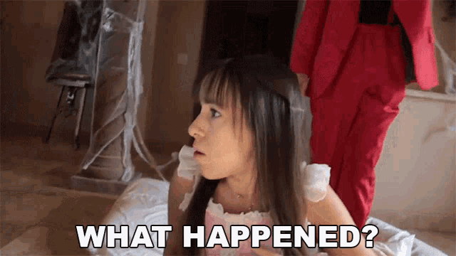 a little girl in a pink dress is laying on the floor asking what happened
