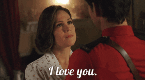a man and a woman are looking at each other and the woman says i love you