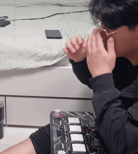 a man wearing glasses is playing a game with a controller that says ' nintendo wii ' on it