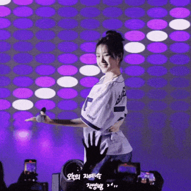 a woman wearing a baseball jersey with the number 75 on it