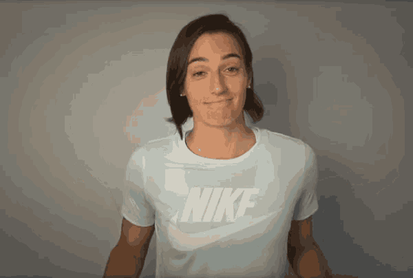 a woman wearing a light blue nike t-shirt