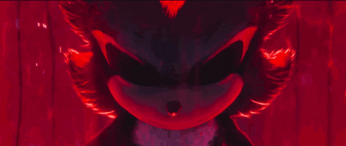 a red light is shining on a person 's hand