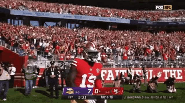 a football player wearing a red jersey with the number 15 on it