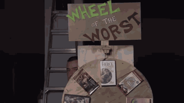 a man stands behind a wheel of the worst