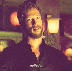 a man with a beard and a black shirt says nailed it