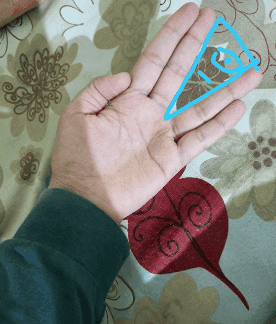 a hand with a blue triangle on it