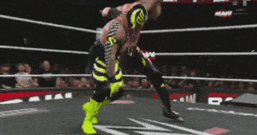 a wrestler is laying on the ground in a ring with netflix written on the floor