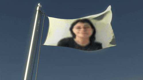 a flag with a picture of a woman flying in the wind