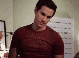 a man wearing a red t-shirt that says ' corse ' on it