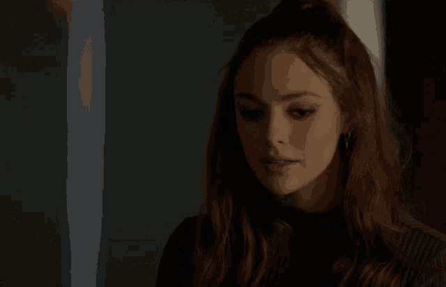 a close up of a woman 's face with red hair