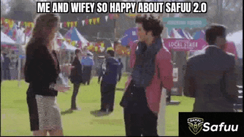 a man in a pink jacket is talking to a woman in a white skirt at a carnival .