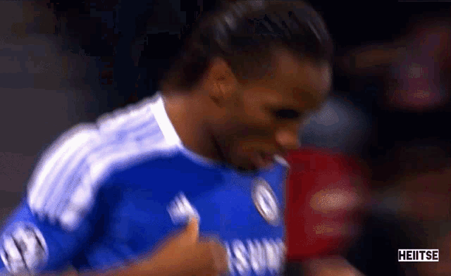 a blurry picture of a soccer player with heitse in the corner