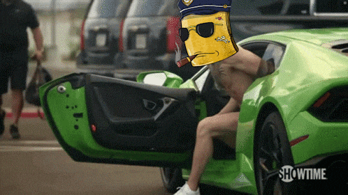 a man is sitting in a green car with showtime on the bottom right