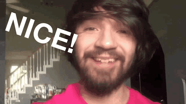 a man with a beard is smiling with the words nice written above him