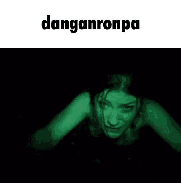 a woman is swimming in the dark with a green light coming from her face .