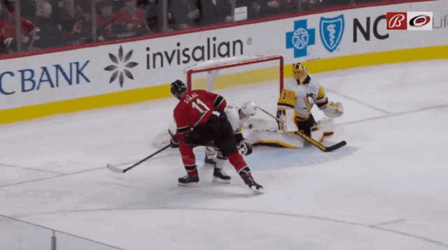a hockey player with the number 11 on his back