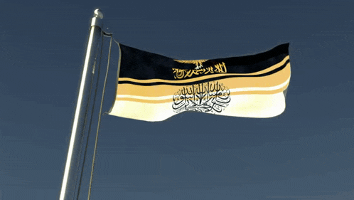 a black and gold flag with arabic writing and an eagle on it