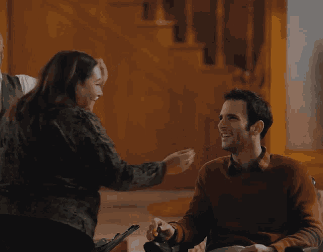 a woman putting her hand on a man 's cheek