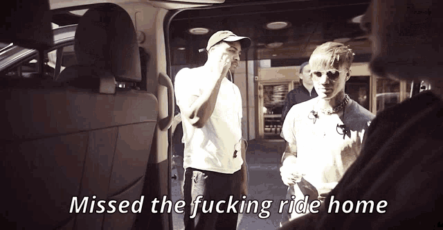 a man in a white shirt says " missed the fucking ride home " in front of two other men