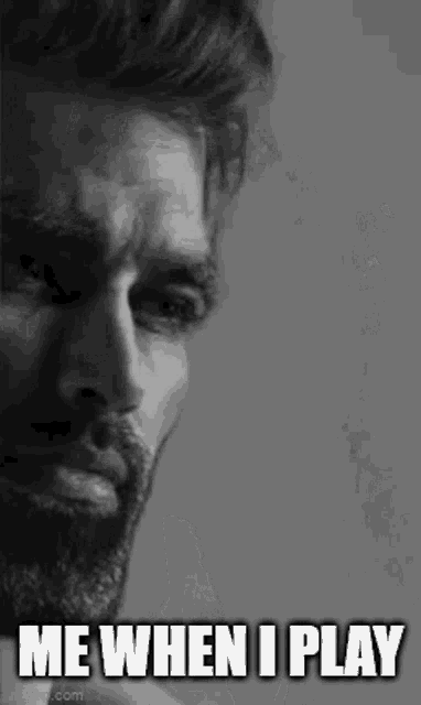 a man with a beard is crying in a black and white photo with the words `` me when i play '' .