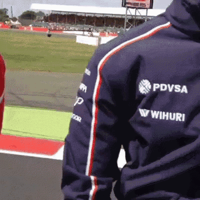 a man wearing a blue jacket with pdvsa and wihiuri written on it