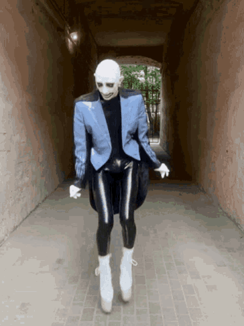a person wearing a blue jacket black pants and white boots