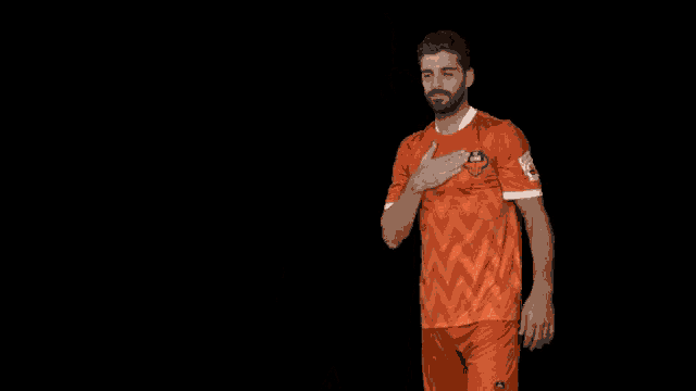 a man wearing an orange shirt that says gsr on it