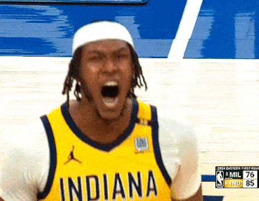 a basketball player wearing a yellow indiana jersey is yelling